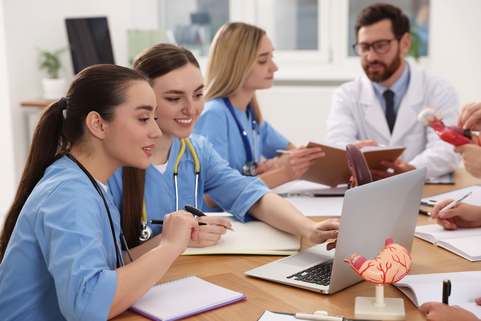 Medical students in uniforms studying at university